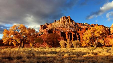 Majestic Autumn Landscape with Golden Trees and Cliffs wallpaper