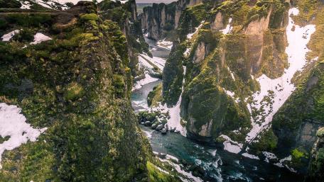 Canyon Serenity with Flowing Stream and Majestic Cliffs wallpaper