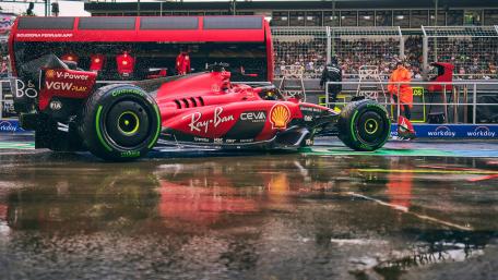 Ferrari F1 in Action Amidst the Rainy Race Day wallpaper