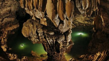Mysterious Cavern with Luminous Pools wallpaper