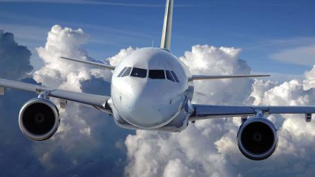Airliner Soaring Through Fluffy Clouds wallpaper