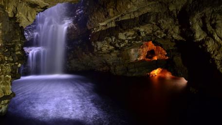 Majestic Cave Waterfall Scene wallpaper