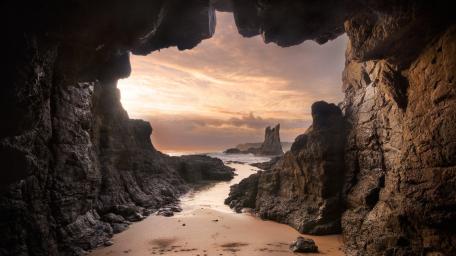 Serene Cave View Over Coastal Landscape wallpaper