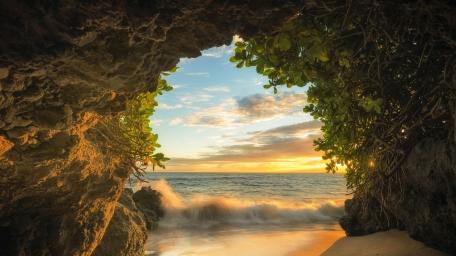 Serene Sunset Through Coastal Cave View wallpaper