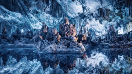 Enchanting Reflection in a Blue Ice Cave wallpaper