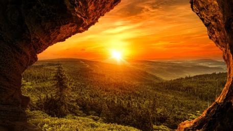 Majestic Sunset Through a Cave Opening wallpaper