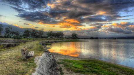 Serene Bench by the Shore at Dusk wallpaper