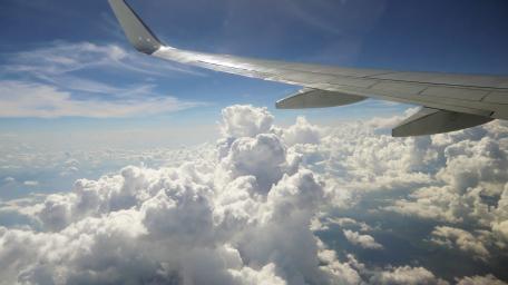Aerial Views of Clouds and Airplane Wing Above the Sky wallpaper