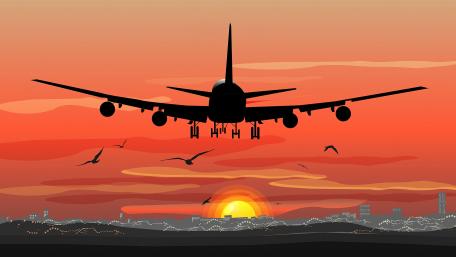 Airplane Silhouette Against Vibrant Sunset wallpaper