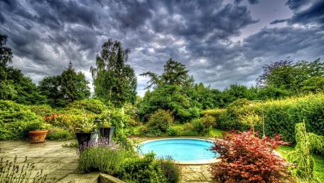 Garden Oasis Tranquility with Stormy Skies wallpaper