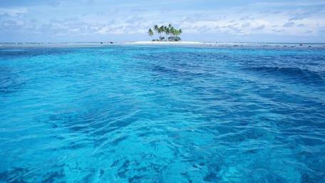 Tropical Islet Oasis with Crystal Blue Waters wallpaper