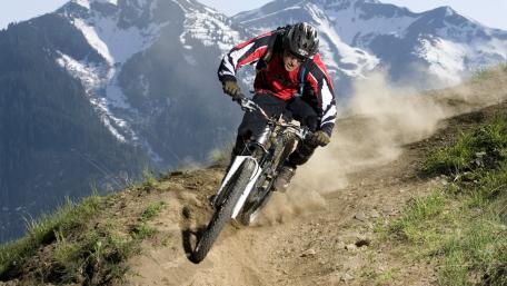 Thrilling Downhill Mountain Biking Adventure wallpaper