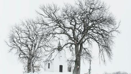 Winter's Silent Embrace: Snow-covered Church in Black and White wallpaper