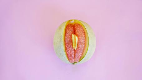 Juicy Melon with a Playful Twist on a Pink Background wallpaper
