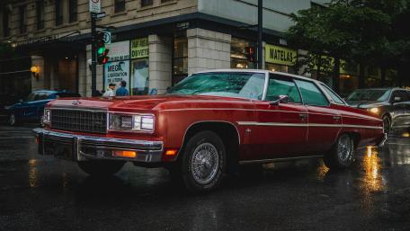 Red Classic Chevrolet Caprice on Wet Urban Streets wallpaper