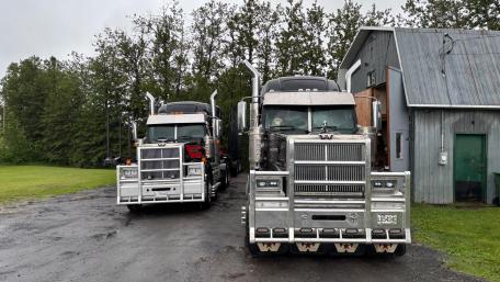 Powerful Trucks Lined Up in Rustic Setting wallpaper
