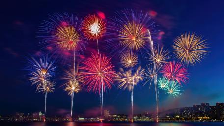 Dazzling Fireworks Over City Skyline wallpaper
