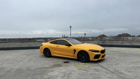 Yellow BMW M8 Muscle Car on Urban Rooftop wallpaper