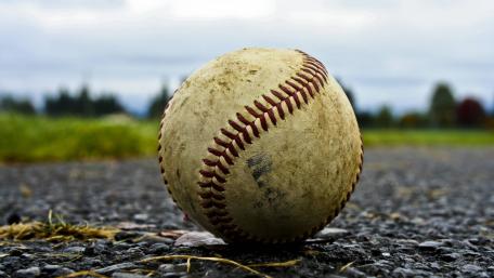 Baseball on Rough Ground Captures Game Spirit wallpaper