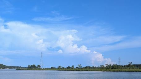 Serene River Landscape with Fluffy Clouds wallpaper