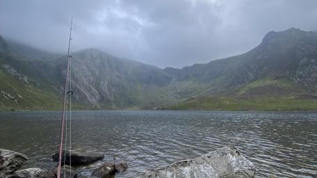 Serene Fishing Lake in Misty Mountains wallpaper