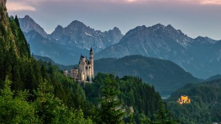 Enchanted Castles Amidst Majestic Alpine Peaks wallpaper