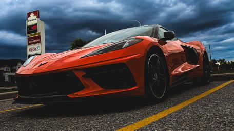 Red Chevrolet Corvette Against a Stormy Sky wallpaper