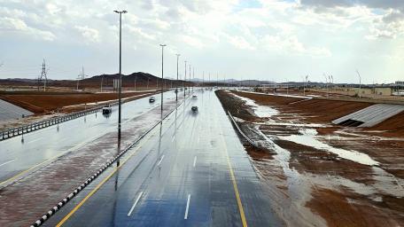 Wet Highway Through Desert Landscapes wallpaper