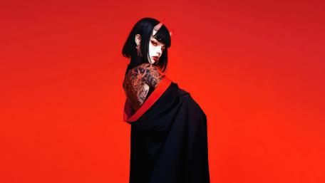 Tattooed Horned Girl on Vivid Red Background wallpaper