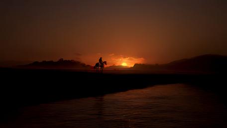 Sunset Rider in a Mystic Landscape wallpaper