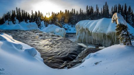 Snowy Winter Stream Amid Icy Peaks wallpaper