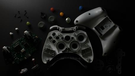 Xbox Controller Disassembled on Black Background wallpaper