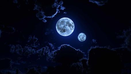 Twin Moons Illuminating the Midnight Sky wallpaper