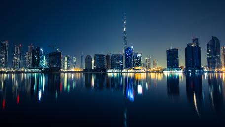 Dubai's Glittering Nighttime Horizon in Blue wallpaper
