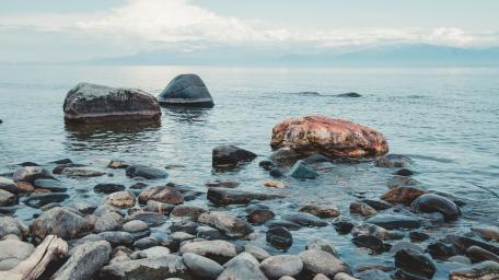 Boulders by Tranquil Waterscape wallpaper