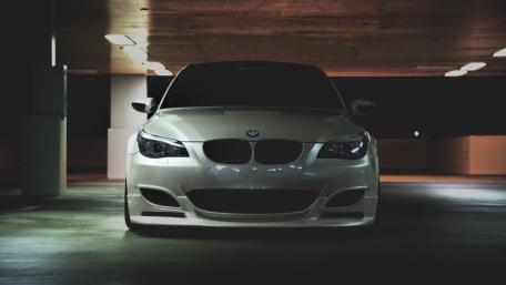 BMW M5 Striking Elegance in Shadowy Parking Garage wallpaper