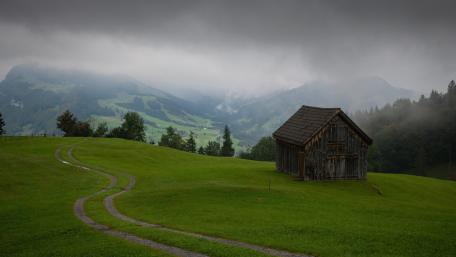 Rustic Cabin Amid Misty Hills wallpaper