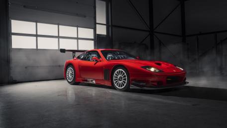 Sleek Red Supercar in Industrial Glow wallpaper