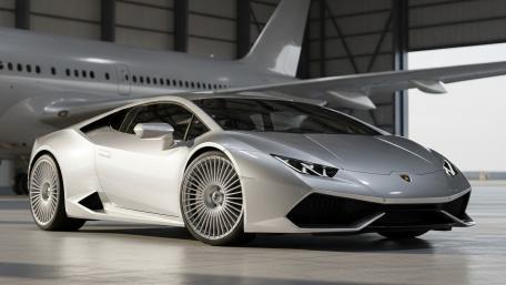 Sleek Silver Supercar in Spacious Hangar wallpaper