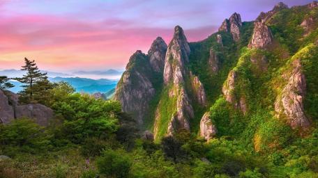 Majestic Peaks Glow Under Vibrant Sunset Sky wallpaper