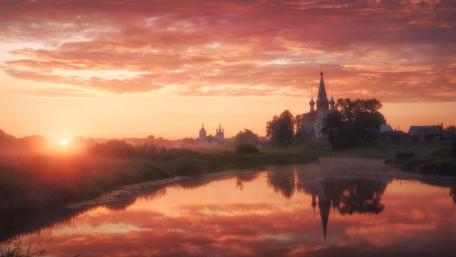 Serene Sunrise Over a Tranquil Village Landscape wallpaper