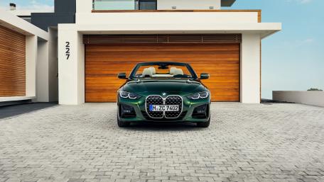 Elegant BMW Convertible Parked in Modern Driveway wallpaper