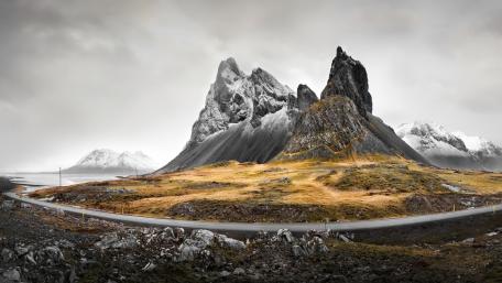 Majestic Peaks Under Stormy Skies in Eystrahorn wallpaper