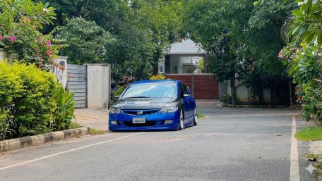 Sleek Blue Honda on Serene Street Scene wallpaper
