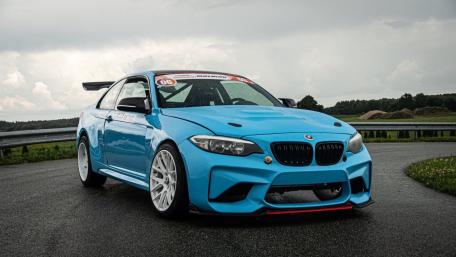 Sleek Blue BMW on a Wet Track wallpaper
