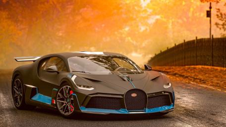 Midnight Hypercar Silhouette Cruising Under a Golden Autumn Sunset Sky wallpaper