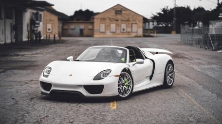 White Porsche 918 Spyder Supercar in Industrial Street Setting wallpaper
