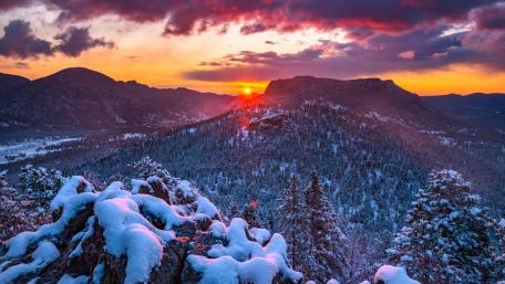 Sunset Glow Over Snowy Evergreen Mountain Forest wallpaper