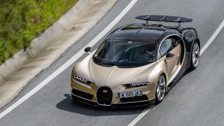 Golden Bugatti Chiron in Motion on Open Road wallpaper