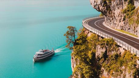 Curving Cliffside Road Above a Cruise on Thunersee Switzerland wallpaper